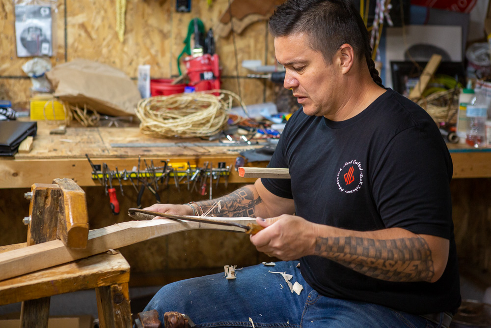 Jack Johnson at workbench, carving lacrosse stick